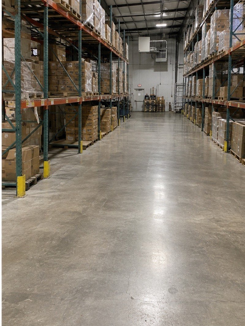 A clean commercial warehouse aisle after a junk removal job
